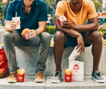 Two men eating wendy's at Curaçao National Airport